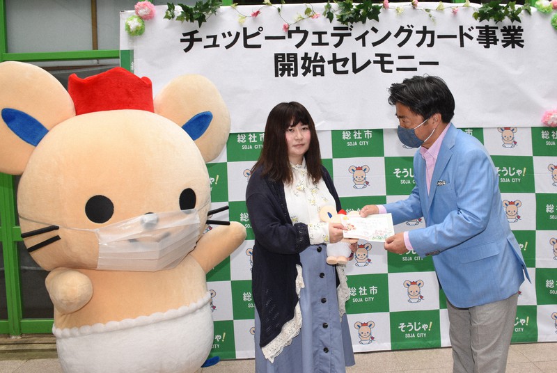 片岡聡一・総社市長からウエディングカードを受け取る白根有貴さん(中央)。左がチュッピー=岡山県総社市中央1の同市役所で2020年5月18日午前11時6分、松室花実撮影