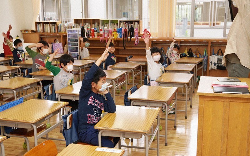 先生のあいさつに元気に応える多摩市立第二小学校の1年生たち。感染防止策としてクラスの半分は午後の登校で、1人おきに座っていた=同小で2020年6月1日午前9時16分、黒川将光撮影