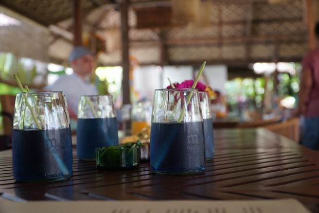 ウエルカムドリンクのコップは飲料水のグラスをアップサイクル。マドラーはレモングラスの茎=筆者提供