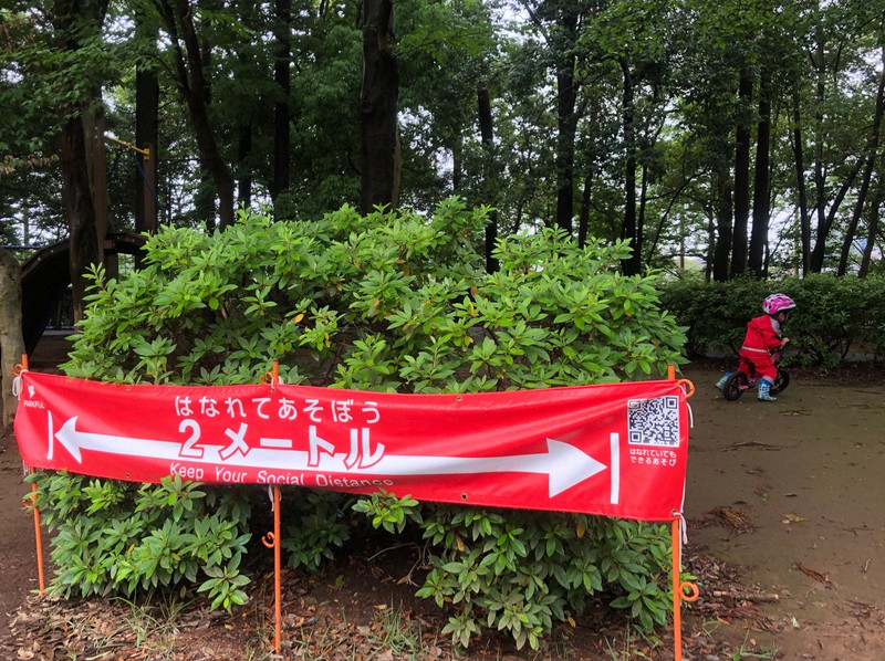 公園で他人と2メートル離れて遊ぶよう呼びかける横断幕。政府の「新しい生活様式」でも、人との距離を2メートル(最低1メートル)空けることが実践例として示されている=千葉県流山市で6月14日午後、尾崎修二撮影