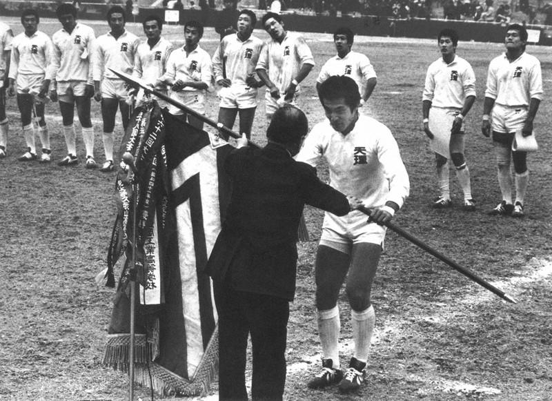 優勝旗を受け取る天理のCTB山川=近鉄花園ラグビー場で1984年1月7日撮影