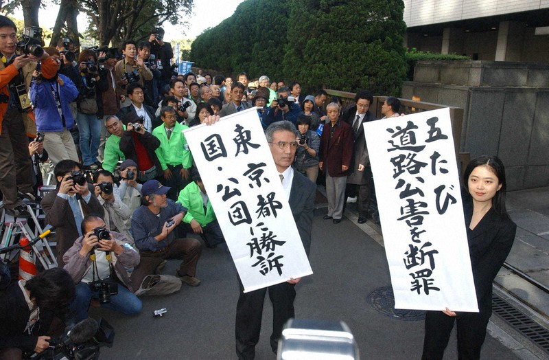 1審東京地裁判決で勝訴の垂れ幕を掲げる東京大気汚染訴訟の原告団と弁護士=東京・霞が関の東京地裁で2002年10月29日、小林努撮影
