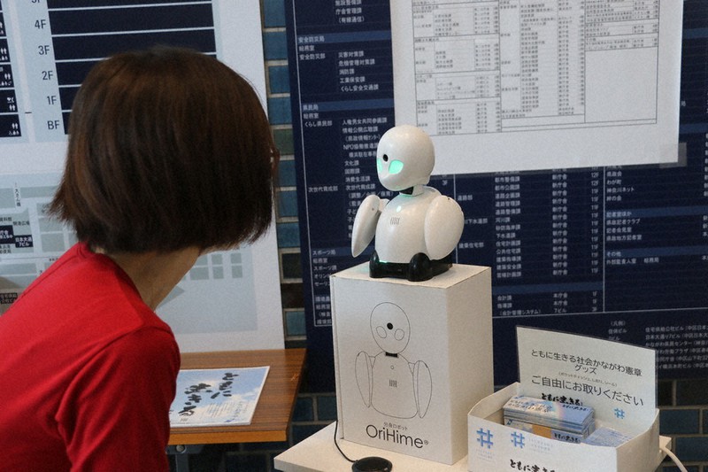 神奈川県庁内を案内する分身ロボット「OriHime(オリヒメ)」。移動が困難な障害者が、分身ロボットを通じて話しかけてきた人と会話をしている=横浜市中区の県庁で、木下翔太郎撮影