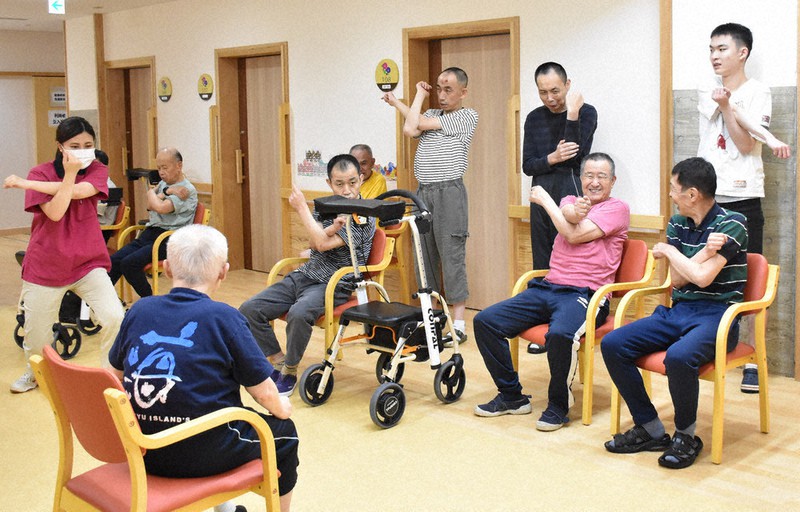 第一野の花学園で、レクリエーション時に職員と共に体を動かす利用者ら