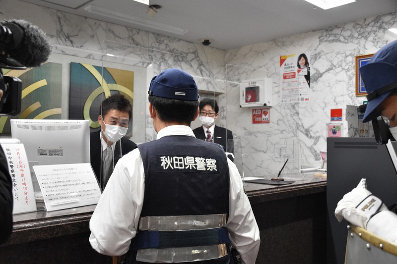 駆けつけた警察に強盗の特徴を説明する従業員=秋田市大町4で2020年10月8日午前11時21分、猪森万里夏撮影