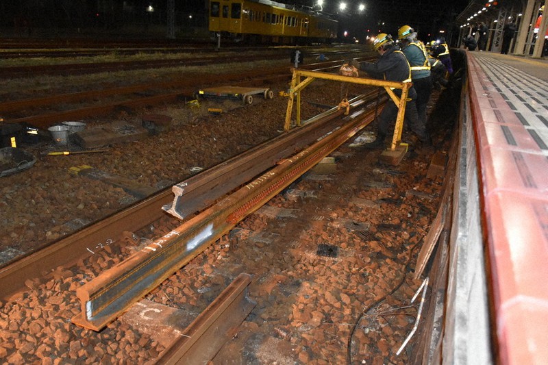 終電後の駅で線路を交換する作業員
