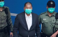 Jimmy Lai, center, who founded the Apple Daily tabloid, is escorted by Correctional Services officers to get in a prison van before appearing in a court, in Hong Kong, on Dec. 12, 2020. (AP Photo/Kin Cheung)