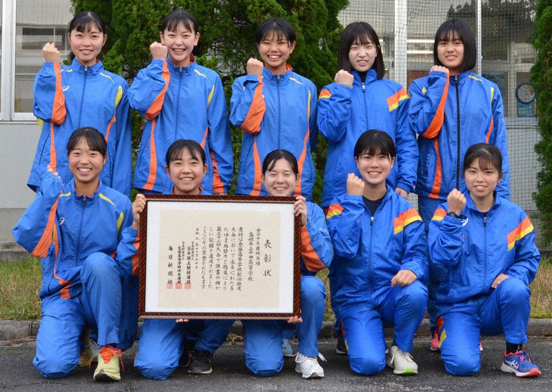 全国高校駅伝10年連続出場の表彰状を受け取り、笑顔の平田・女子チームの選手たち=島根県出雲市平田町で、岩崎誠撮影