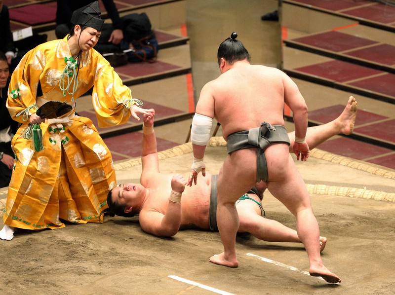 大相撲初場所10日目、「待った」がかかった立ち合いで朝玉勢と頭からぶつかり、倒れる幕下の湘南乃海(奥)=東京・両国国技館で2021年1月19日