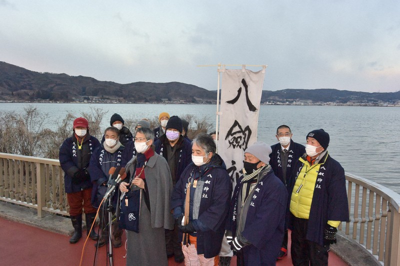 波立つ諏訪湖を背に「明けの海」を宣言した宮坂清宮司(前列右から3人目)=長野県諏訪市豊田の舟渡川河口で2021年2月3日午前6時55分、宮坂一則撮影
