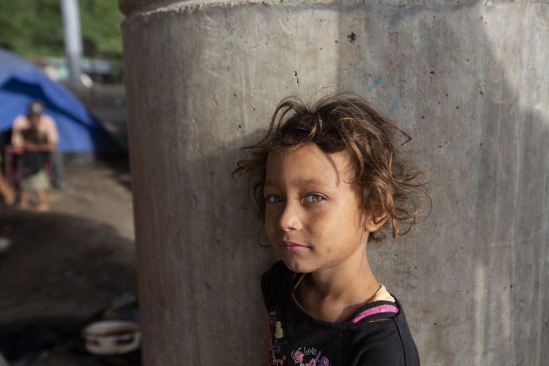 2020年秋に起きたハリケーンの影響で自宅をなくした9歳の少女。家族とともに橋の下で暮らしているという＝ホンジュラス北西部サンペドロシュラで2021年1月11日、AP