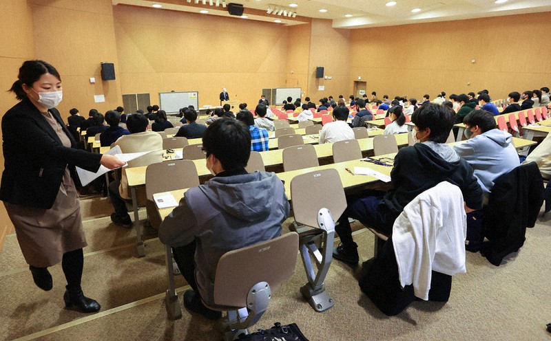 受験上の注意が配布され、試験開始を待つ受験生ら=札幌市北区の北海道大で、代表撮影