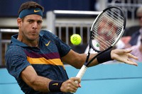 In this June 19, 2019, file photo, Juan Martin Del Potro of Argentina plays a return to Denis Shapovalov of Canada during the Queens Club tennis tournament in London. (AP Photo/Kirsty Wigglesworth)