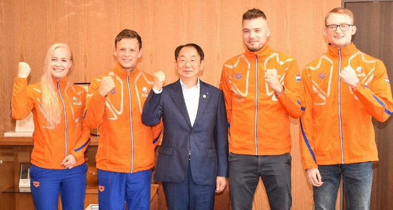穂積志市長(中央)と記念撮影する障害者水泳のオランダ代表チーム=秋田市役所で2019年7月、高野裕士撮影