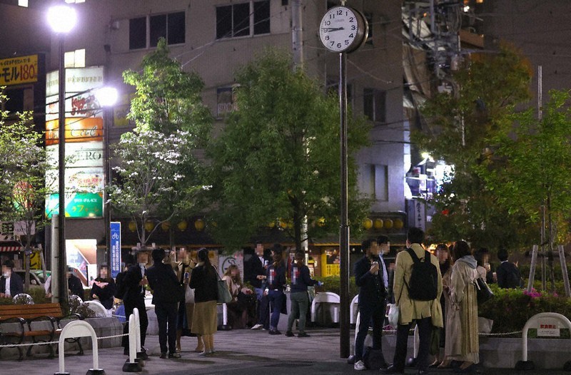 「まん延防止等重点措置」適用初日、午後8時を過ぎてからも新橋駅近くの公園で飲食を続ける人たち=東京都港区で2021年4月12日午後8時46分、宮武祐希撮影(画像の一部を加工しています)