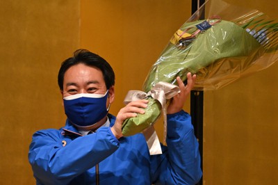 参院長野選挙区補選で当選が確実となり、贈られた花束を手に笑顔の羽田次郎氏＝長野市で2021年4月25日午後8時5分、宮間俊樹撮影