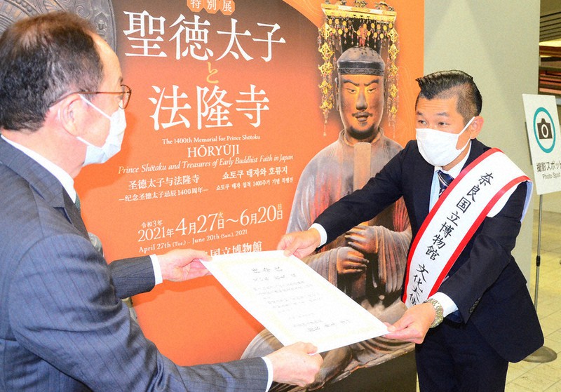 井上洋一館長(左)から任命状を受け取る哲夫さん=奈良市の奈良国立博物館で2021年5月7日午後1時10分、加藤佑輔撮影