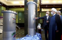 In this April 10, 2021 file photo released by the official website of the office of the Iranian Presidency, President Hassan Rouhani, second right, listens to head of the Atomic Energy Organization of Iran Ali Akbar Salehi while visiting an exhibition of Iran's new nuclear achievements in Tehran, Iran. (Iranian Presidency Office via AP)