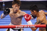 Naoya Inoue, of Japan, hits Michael Dasmarinas, of the Philippines, in a bantamweight title fight Saturday, June 19, 2021, in Las Vegas. (AP Photo/John Locher)