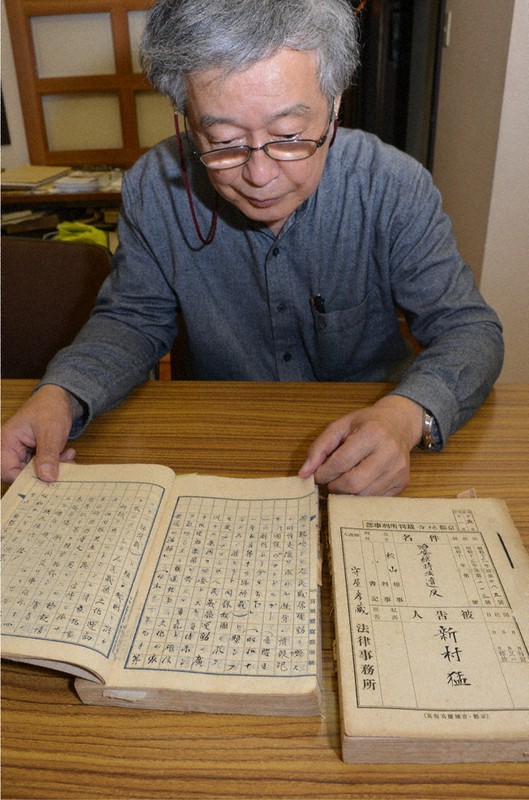 治安維持法違反容疑で逮捕・勾留された新村猛の予審調書を見る、新村の次男恭さん=京都市北区で2020年10月、南陽子撮影