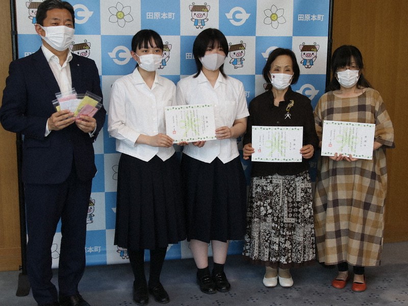 森町長(左)から感謝状を贈られたボランティア有志と磯城野高の生徒代表=奈良県田原本町役場で、姜弘修撮影