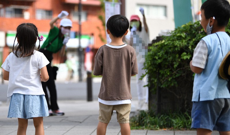 東京都議選の候補者(奥右)の街頭演説を見る子どもたち=東京都中央区で2021年6月29日午後3時31分、丸山博撮影(画像の一部を加工しています)