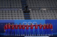 Members of Serbia's men's water polo team sing their national anthem in front of empty seats after receiving their gold medals at the 2020 Summer Olympics, Aug. 8, 2021, in Tokyo, Japan. (AP Photo/Mark Humphrey)