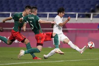 In this file photo, Kaoru Mitoma is seen scoring Japan's first goal against Mexico during the men's bronze medal soccer match at the Tokyo Olympics, Aug. 6, 2021, in Saitama, Japan. (AP Photo/Gregory Bull)