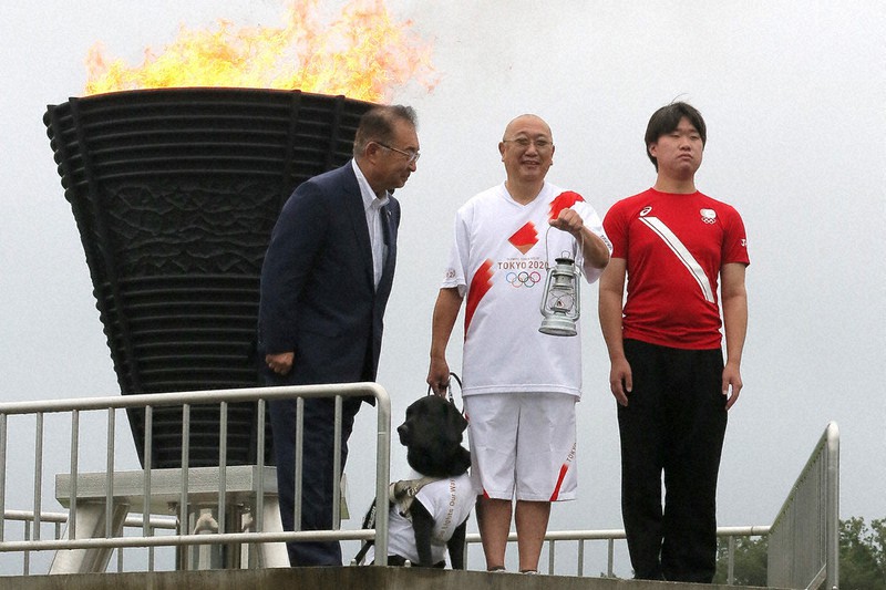 盲導犬のトラヴィスと採火式に臨んだ若山拓真さん(中央)=宮城県石巻市で2021年8月15日午前10時17分、和田大典撮影