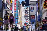 People wearing face masks to protect against COVID-19 walk past a crossing in Shinjuku, an entertainment district of Tokyo, on Sept. 20, 2021. (AP Photo/Kiichiro Sato)