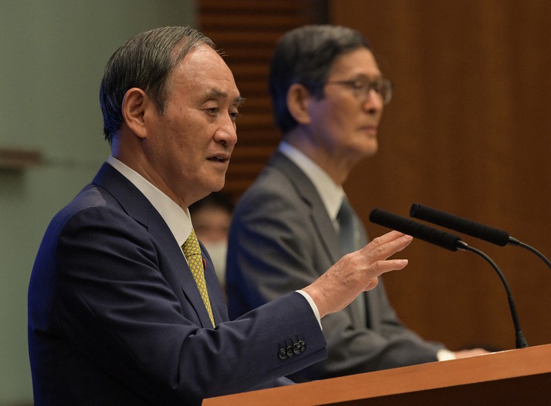 新型コロナウイルス感染症対策本部の会合後、記者会見する菅義偉首相(左)。右奥は新型コロナウイルス感染症対策分科会の尾身茂会長=首相官邸で2021年9月28日午後7時51分、竹内幹撮影