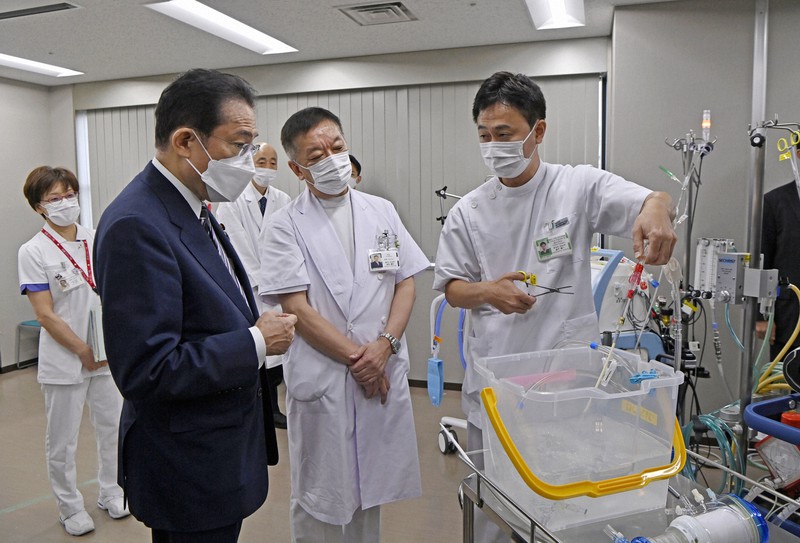 都立墨東病院の関係者から説明を受ける岸田文雄首相(手前左)。中央は足立健介院長=東京都墨田区で2021年10月9日午前9時32分(代表撮影)
