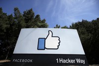 In this April 14, 2020 file photo, the thumbs up Like logo is seen on a sign at Facebook headquarters in Menlo Park, California. (AP Photo/Jeff Chiu)