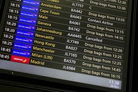 A departures screen displays a cancelled flight to Johannesburg and a message to contact the airline for a scheduled flight to Capetown, at London's Heathrow Airport, on Nov. 26, 2021. (AP Photo/Alberto Pezzali)