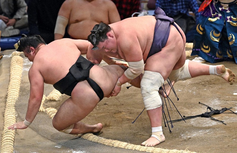 照ノ富士(右)が小股すくいで霧馬山を降す=福岡国際センターで2021年11月14日、徳野仁子撮影