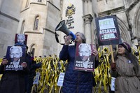 Protestors demonstrate outside the High Court in London on Dec. 10, 2021. (AP Photo/Frank Augstein)