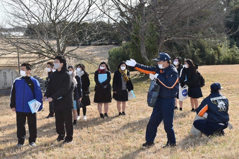 小貝川堤防決壊跡で当時の模様を聞く生徒たち=茨城県龍ケ崎市川原代町で2022年1月15日、庭木茂視撮影