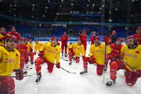 China players listen to their coaching staff during a men's hockey practice session at the 2022 Winter Olympics, on Jan. 30, 2022, in Beijing. (AP Photo/Petr David Josek)