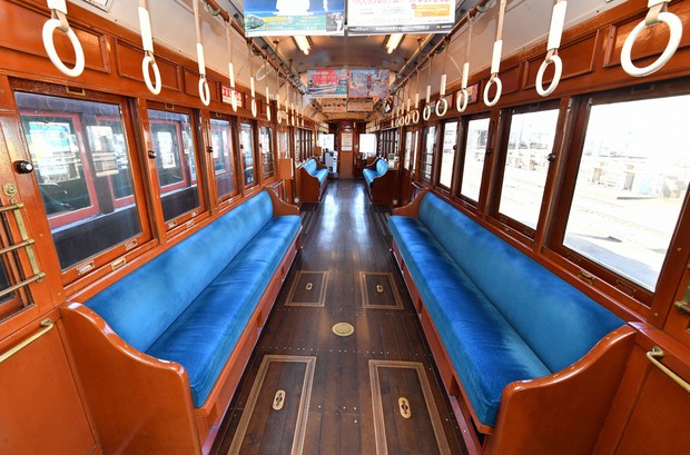 Stylish Showa era retro tram still rattling and rolling in Osaka