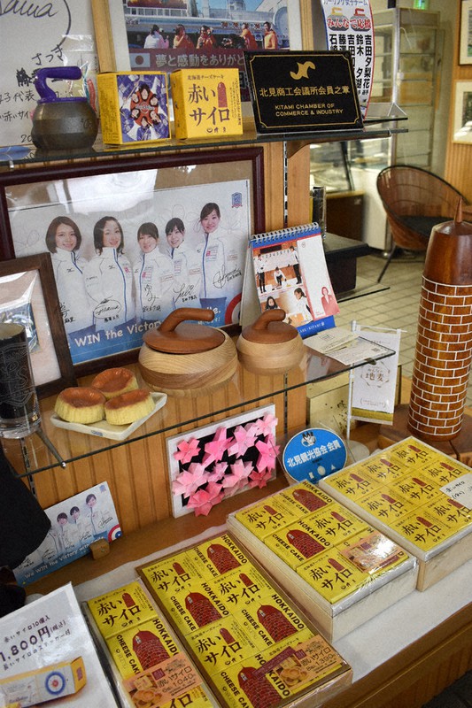 「清月」店内の赤いサイロ販売コーナー。ロコ・ソラーレの写真も飾られている=北海道北見市で2022年2月16日、本多竹志撮影
