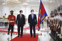 In this photo released by Cambodia's Council of Ministry, Cambodian Prime Minister Hun Sen, center, reviews an honor guard with his Japanese counterpart Fumio Kishida at Peace Palace, in Phnom Penh, Cambodia, Sunday, March 20, 2022. (Saoyorn Udom/Cambodia's Government Cabinet via AP)