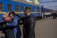 Olga Nikitina, center, who escaped the besieged city of Mariupol embraces her sister after arriving in Lviv, western Ukraine, on March 20, 2022. (AP Photo/Bernat Armangue)