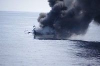 The tuna longline fishing boat 51st Yujinmaru is seen on fire in this image provided by the 10th Regional Coast Guard Headquarters.