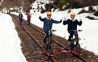 People enjoy bicycle-driven trolley rides on an abandoned railway track at the "Rail Mountain Bike Gattan Go!!" facility in Hida, Gifu Prefecture, on March 19, 2022. (Mainichi/Tadayuki Otake)