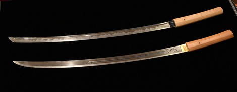 Katana works by swordsmith Yoshindo Yoshihara are seen in Tokyo's Katsushika Ward on Feb. 14, 2022. The one in the back shows beautiful "hamon" wave patterns along the edges of the blade. (Mainichi/Emi Naito) =Click/tap photo for more images.