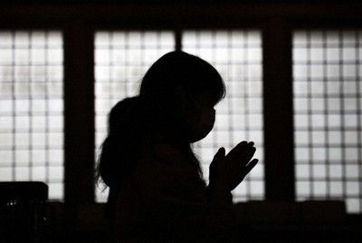 毎月11日、「蓮の会」で鈴木由美子さんは手を合わせる。秀和さんへの「愛」と「哀」を胸に抱き＝宮城県石巻市の西光寺で2022年1月11日