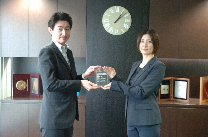 記念の盾を受け取るウィル役員の粟野泉さん(右)=兵庫県宝塚市で2022年5月26日午後1時6分、稲垣淳撮影
