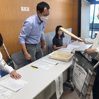 奈良県選管の届け出受け付けリハーサルで「七つ道具」を渡す手順などを確認する職員ら＝同県庁で、久保聡撮影