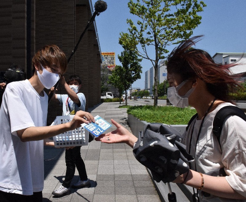 参院選の投票啓発チラシが入ったマスクを常葉大の学生(写真右)に配布する「若者選挙パートナー」の大学生=静岡市駿河区弥生町の常葉大学静岡草薙キャンパスで2022年6月28日、皆川真仁撮影
