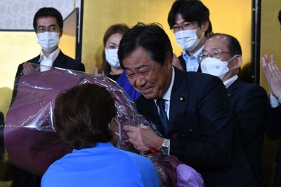 当選確実の一報を受けて花束を受け取る青木一彦氏（中央）＝松江市殿町で2022年7月10日午後8時5分、目野創撮影
